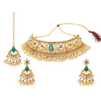 Traditional golden stone jewellery set with green center and kundan by leshya 1