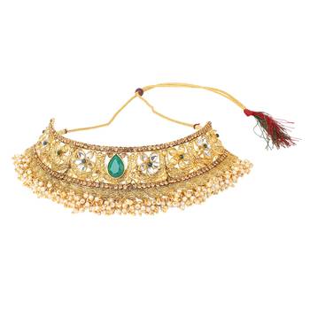 Traditional golden stone jewellery set with green center and kundan by leshya 2
