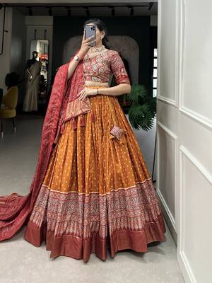 Orange Color Dola Silk With Bandhani And Ajarakh Print Foil Work Lehenga Choli For Women 3