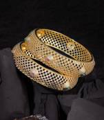 Women gold-plated pink and green stone-studded bangles