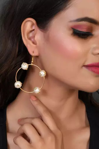 Gold toned circular western drop earrings