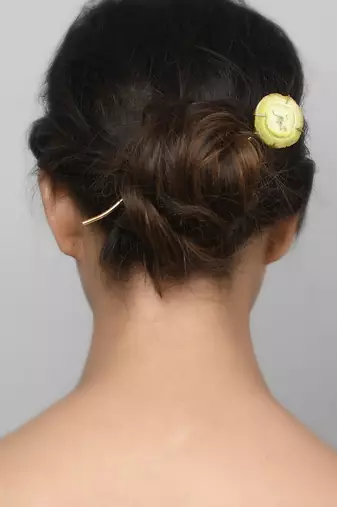 Women gold toned hair stick