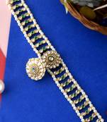 Gold plated kundan & green stone studded matha patti