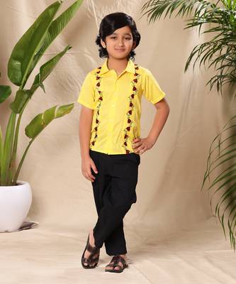Yellow embroidered shirt with black trousers 1