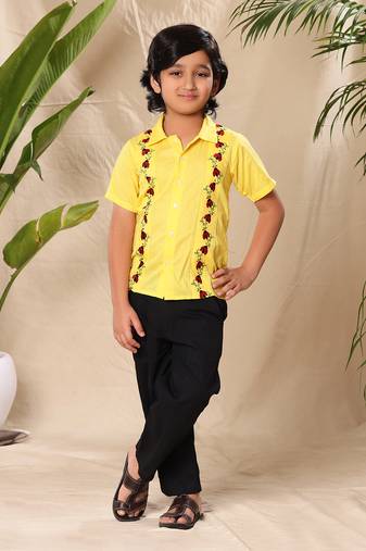 Yellow embroidered shirt with black trousers