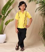 Yellow embroidered shirt with black trousers