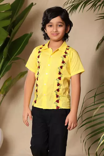 Yellow embroidered shirt with black trousers