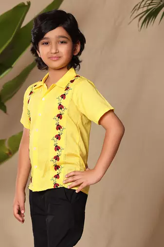 Yellow embroidered shirt with black trousers