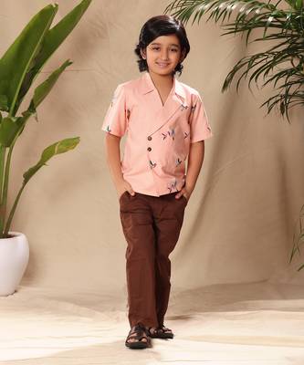 Pink embroidered blazer style shirt with brown trousers 1