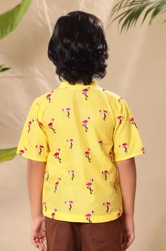 Yellow embroidered no collar short kurta with brown trousers