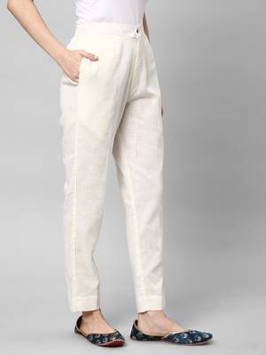 A off-white ankle length coton linen pant with plain belt in front. 3