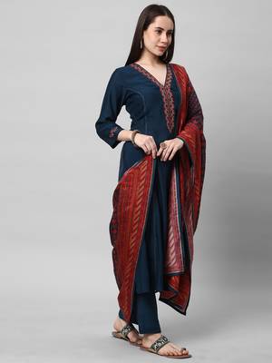 A machine embroidered kurta with self bottom paired with printed dupatta. 4