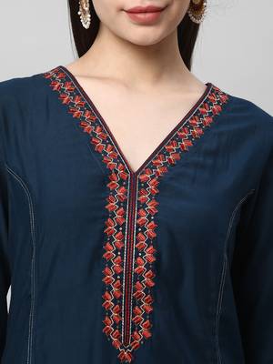 A machine embroidered kurta with self bottom paired with printed dupatta. 5