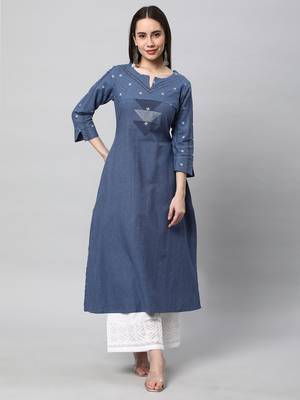 A line cotton kurta with a woven trim and hand embroidery. 1