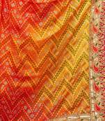 Yellow  chiffon bandhani saree with unstitched blouse piece