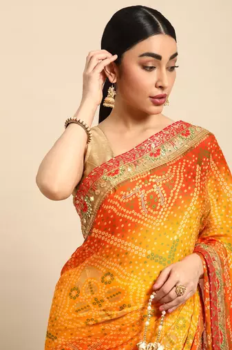 Yellow bandhani saree with lace border and unstitched blouse piece
