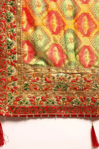 Yellow bandhani saree with lace border and unstitched blouse piece