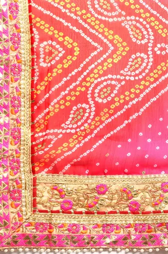Peach bandhani saree with lace border and unstitched blouse piece