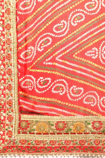 Yellow bandhani saree with lace border and unstitched blouse piece