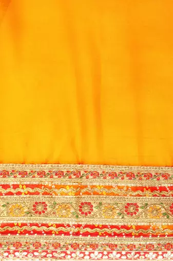 Yellow bandhani saree with lace border and unstitched blouse piece