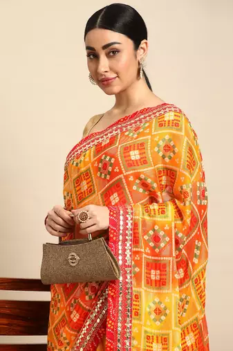 Yellow bandhani saree with lace border and unstitched blouse piece
