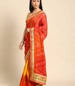 Yellow bandhani saree with lace border and unstitched blouse piece