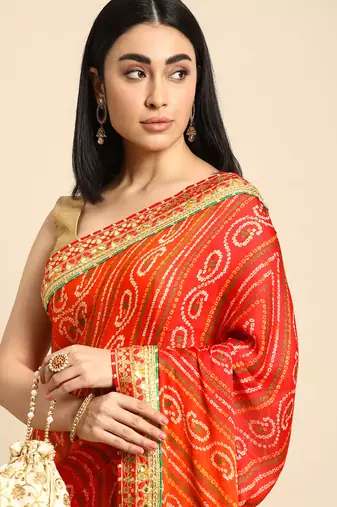 Yellow bandhani saree with lace border and unstitched blouse piece
