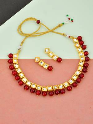 Women gold-plated & red kundan stone-studded jewellery set 1