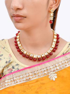 Women gold-plated & red kundan stone-studded jewellery set 2