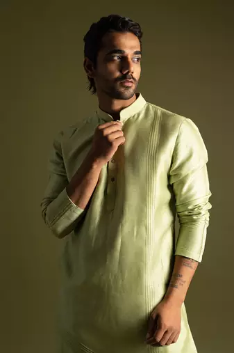 Pistachio green silk kurta with cream pants