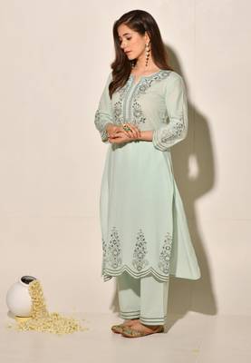 A-line cotton kurta set with embroidery details, cutwork details, paired up with pants. 2