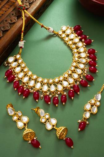 Gold plated kundan stone studded jewellery set with pair of earring and mangtikka