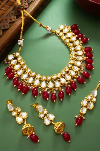 Gold plated kundan stone studded jewellery set with pair of earring and mangtikka