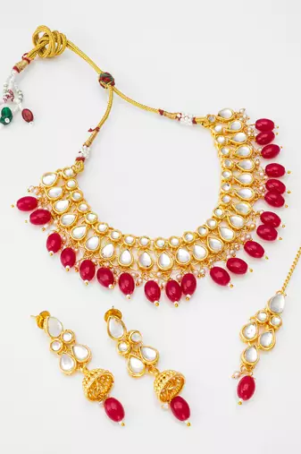 Gold plated kundan stone studded jewellery set with pair of earring and mangtikka
