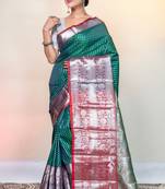 kanjivaram saree in green color with silver zari woven motifs and border
