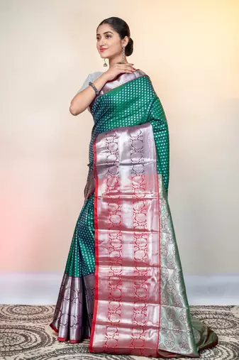 kanjivaram saree in green color with silver zari woven motifs and border