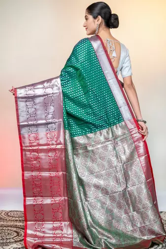 kanjivaram saree in green color with silver zari woven motifs and border