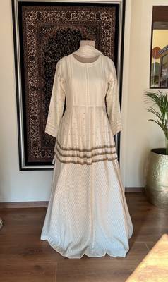 This off white dress has a peplum top with antique handwork done in three layers with a banarasi skirt 2