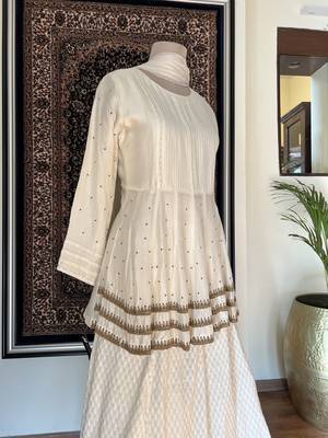 This off white dress has a peplum top with antique handwork done in three layers with a banarasi skirt 3
