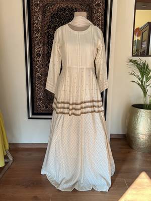 This off white dress has a peplum top with antique handwork done in three layers with a banarasi skirt 4