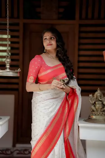 White to red ombre soft silk saree with , rich pallu, and cotton tassels. paired with a soft red woven blouse.