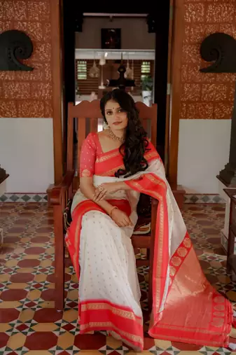 White to red ombre soft silk saree with , rich pallu, and cotton tassels. paired with a soft red woven blouse.