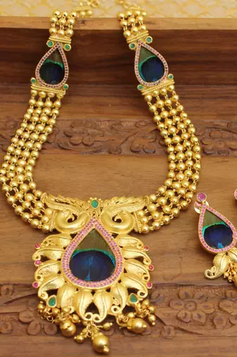 Gold platted peacock feather long necklace with screw back earring