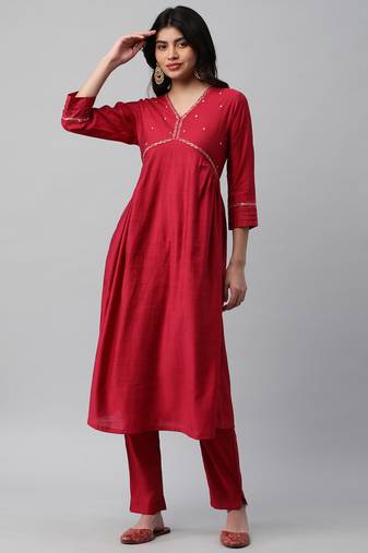A flared with mock placket and machine embroidery.