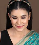 Elegant gold plated hairband with kundan, cz, and color stone embellishments