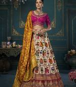 Off white color woven and embroidered dola silk lehenga choli