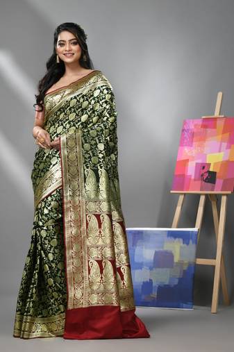 Dark green silk banarasi saree with zari woven floral and paisley designs