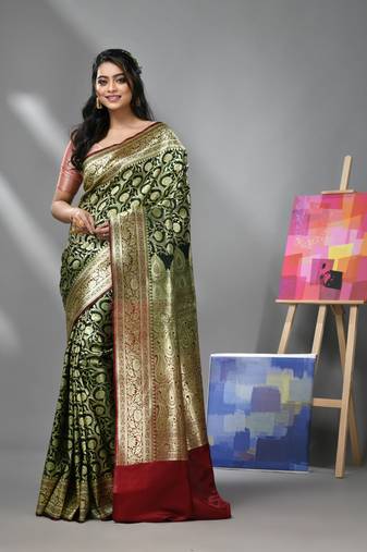 Dark green silk banarasi saree with zari woven floral and paisley designs