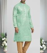 Green silk blend plain floral pattern kurta and churidar set for men