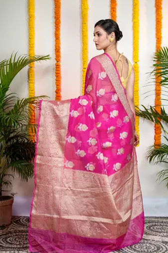 Pink organza silk saree with zari border and floral motifs